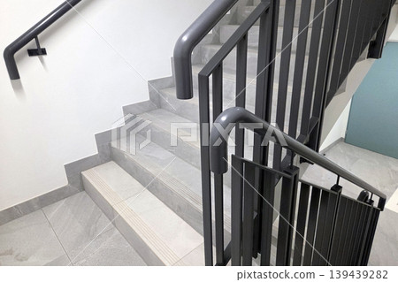 Modern Staircase Interior with Gray Metal Railing in Residential Building Modern Staircase Interior with Gray Metal Railing in Residential Building 139439282