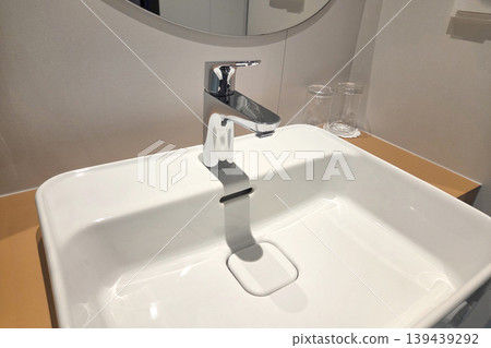 Modern Bathroom Sink with Chrome Faucet in Minimalist Design - Ideal for Interior Design Concepts Modern Bathroom Sink with Chrome Faucet in Minimalist Design - Ideal for Interior Design Concepts 139439292