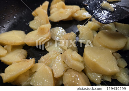 Sauteed Potatoes Cooking in Black Skillet - Perfect for Rustic Culinary Designs Sauteed Potatoes Cooking in Black Skillet - Perfect for Rustic Culinary Designs 139439299