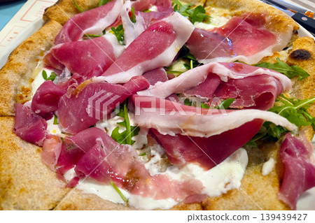 Gourmet Italian Pizza with Prosciutto and Arugula - Ideal for Food Photography and Culinary Design Gourmet Italian Pizza with Prosciutto and Arugula - Ideal for Food Photography and Culinary Design 139439427