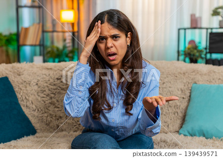 Indian sad woman showing facepalm gesture with frustrated expression of disappointment and regret 139439571