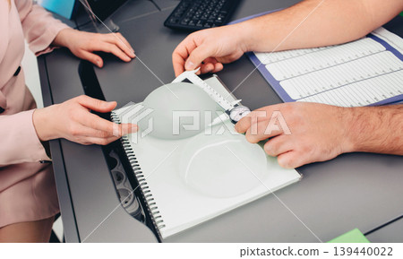 breast augmentation. woman chooses breast implant, close-up breast augmentation. woman chooses breast implant, close-up 139440022