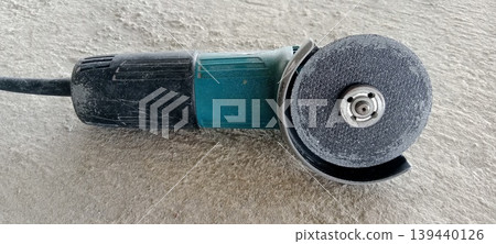 Used hand grinder on a project floor Used hand grinder on a project floor 139440126