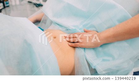 gynecologist palpate the ovaries, close-up female abdomen, during an examination by a gynecologist. 139440219