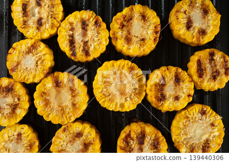 Roasted Sweet Corn Slices with Char Marks on Hot Grill Plate Roasted Sweet Corn Slices with Char Marks on Hot Grill Plate 139440306