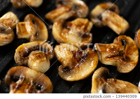 Appetizing Sizzling Grilled Mushrooms on Hot Grill Plate Texture. Appetizing Sizzling Grilled Mushrooms on Hot Grill Plate Texture. 139440309