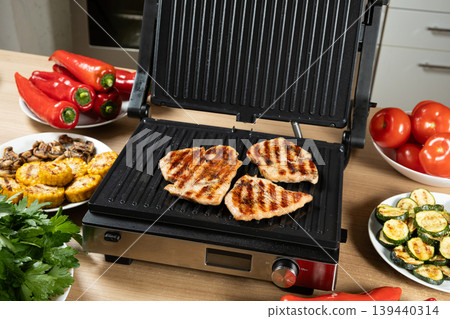 Cooking Fresh Turkey Breast Slices on Modern Home Grill Cooking Fresh Turkey Breast Slices on Modern Home Grill 139440314