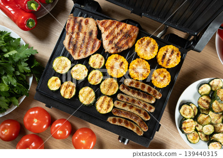Top view of grilling sausages, chicken and vegetables Top view of grilling sausages, chicken and vegetables 139440315