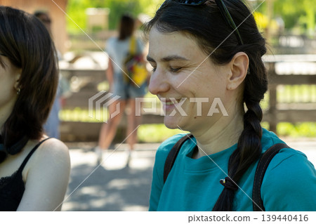 Middle aged woman smiling with eyes closed in summer park 139440416