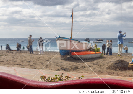 Blurred view of people by the sea through restaurant window 139440539