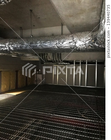 Catwalk with grating floor and piping equipment in the ceiling 139440735