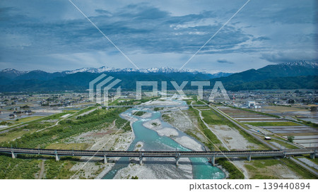 Scenes of the Hokuriku Expressway and Hokuriku Shinkansen viaducts around the Kurobe River in May. Scenes of the Hokuriku Expressway and Hokuriku Shinkansen viaducts around the Kurobe River in May. 139440894