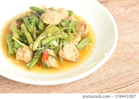 spicy stir fried yard long bean and pork meatball with chili couple basil on plate spicy stir fried yard long bean and pork meatball with chili couple basil on plate 139441007