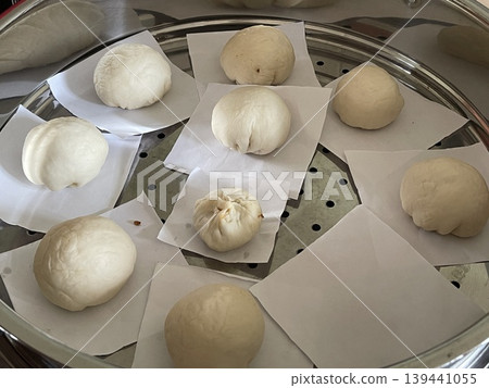 Multiple Raw Handmade Baozi Arranged In Steamer Including One Small Bun Multiple Raw Handmade Baozi Arranged In Steamer Including One Small Bun 139441055