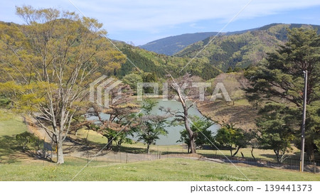 Spring scenery of the mountain range and pond as seen from Kurosawa Ranch 139441373