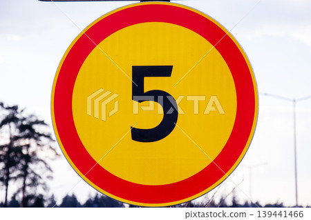 Circular traffic sign with a red border and the number 5 in black on a yellow background Circular traffic sign with a red border and the number 5 in black on a yellow background 139441466