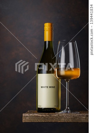 Wine glass and bottle with white wine Wine glass and bottle with white wine 139441834