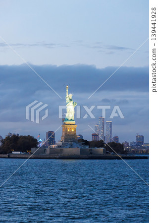 Statue of Liberty at sunset with dramatic sky and warm golden light Statue of Liberty at sunset with dramatic sky and warm golden light 139441928