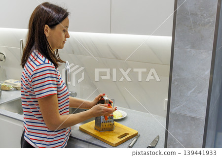Woman cooking food at home kitchen Woman cooking food at home kitchen 139441933