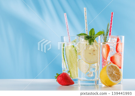 Set of fresh non alcoholic drinks with strawberry cucumber and lemon on blue background 139441993