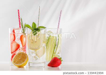 Set of fresh non alcoholic drinks with strawberry cucumber and lemon on white background 139441994