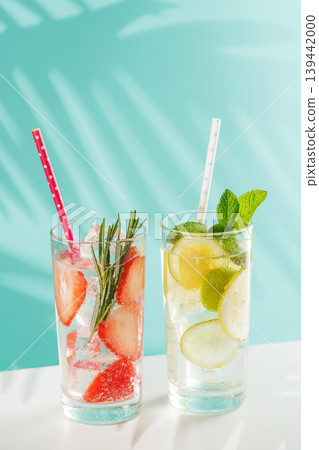 Two fresh non alcoholic drinks with strawberry and lemon on blue background Two fresh non alcoholic drinks with strawberry and lemon on blue background 139442000