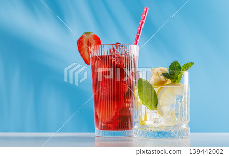 Fresh strawberry and lemon non alcoholic drinks with mint on blue background Fresh strawberry and lemon non alcoholic drinks with mint on blue background 139442002