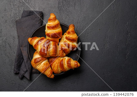 Freshly baked croissants in bowl on dark background 139442076