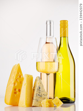 Assorted cheeses and wine on white background Assorted cheeses and wine on white background 139442079