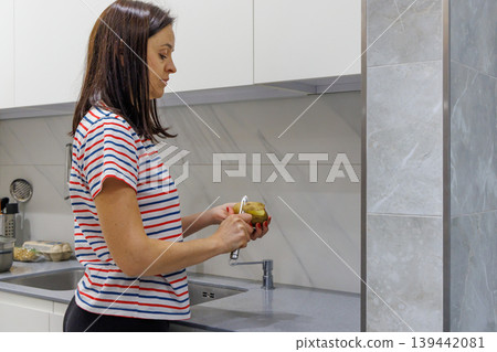 Woman cooking food at home kitchen Woman cooking food at home kitchen 139442081