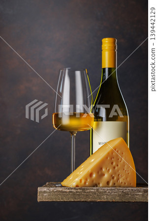 White wine glass with cheese on rustic table White wine glass with cheese on rustic table 139442129