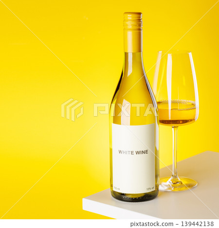 White wine bottle and glass on yellow background elegant drink setup White wine bottle and glass on yellow background elegant drink setup 139442138