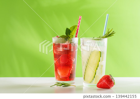 Fresh non alcoholic berry and cucumber drinks with herbs on green background 139442155