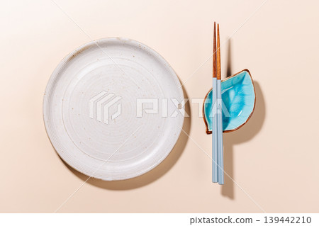 Minimal Sushi Plate with Chopsticks on Beige Background Minimal Sushi Plate with Chopsticks on Beige Background 139442210