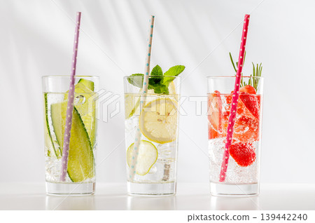 Set of fresh non alcoholic drinks with strawberry cucumber and lemon on white background Set of fresh non alcoholic drinks with strawberry cucumber and lemon on white background 139442240