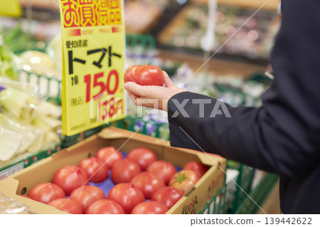 A young woman shopping at a supermarket on her way home from work. 139442622