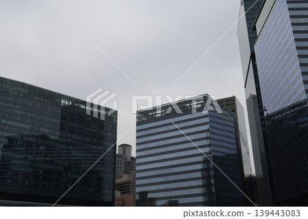 A cityscape with cloudy skies and clusters of skyscrapers. A cityscape with cloudy skies and clusters of skyscrapers. 139443083