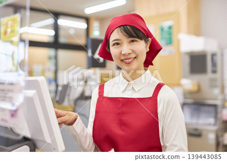 一位在超市收銀台工作的年輕女子 139443085