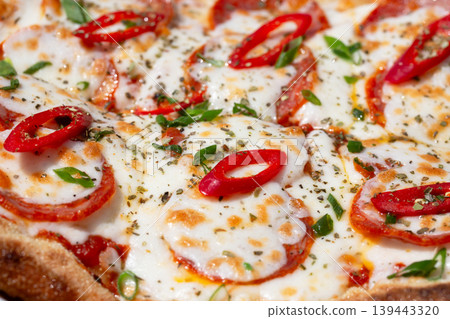 Delicious Neapolitan pizza Margherita close-up. Margarita pizza with tomatoes and paprika. 139443320