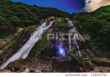 The fantastical Okawa Waterfall on Yakushima Island, illuminated by lights. The fantastical Okawa Waterfall on Yakushima Island, illuminated by lights. 139443781