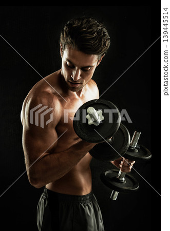 Topless, black background or man in dumbbell workout, training or exercise in studio for power. Fitness model, dark or ripped person with healthy body, shadow or biceps muscle for wellness or lifting Topless, black background or man in dumbbell workout, training or exercise in studio for power. Fitness model, dark or ripped person with healthy body, shadow or biceps muscle for wellness or lifting 139445514