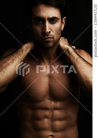 Abs, black background or portrait of model for workout, training or exercise in studio for fitness. Man, dark shadow or ripped male person with healthy body, six pack or stomach for wellness in Italy Abs, black background or portrait of model for workout, training or exercise in studio for fitness. Man, dark shadow or ripped male person with healthy body, six pack or stomach for wellness in Italy 139445528