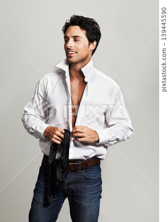 Smile, fashion and young man in a studio with formal, cool trendy and elegant outfit with confidence. Happy, handsome and male model from Canada with classy style posing isolated by gray background. Smile, fashion and young man in a studio with formal, cool trendy and elegant outfit with confidence. Happy, handsome and male model from Canada with classy style posing isolated by gray background. 139445590