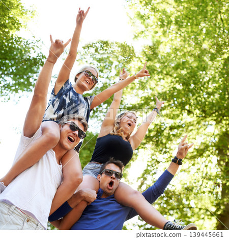 Music, festival and carrying friends on shoulders with cheers of fans in celebration and freedom. Happy, people or sign for rock n roll at concert with trees above or men support girlfriends in woods Music, festival and carrying friends on shoulders with cheers of fans in celebration and freedom. Happy, people or sign for rock n roll at concert with trees above or men support girlfriends in woods 139445661