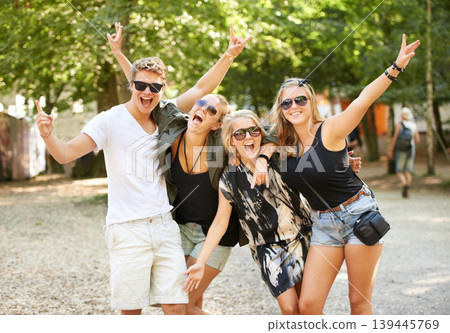 Celebration, hug and friends at a park for festival, concert or happy social gathering. Face, fun and people in a forest with freedom, energy and excited for event, reunion or party with rocker hands Celebration, hug and friends at a park for festival, concert or happy social gathering. Face, fun and people in a forest with freedom, energy and excited for event, reunion or party with rocker hands 139445769
