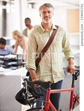 Mature, businessman and bicycle in office with portrait and manager of sustainable company. Ceo, boss and job with eco friendly commute in morning with smile in a creative agency of a professional 139445781