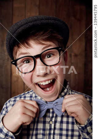 Portrait, glasses and excited kid with bow tie for fashion, retro or vintage. Happy face, nerd and smile of young boy child in hat, geek in stylish or trendy eyewear and funny laugh in New Zealand Portrait, glasses and excited kid with bow tie for fashion, retro or vintage. Happy face, nerd and smile of young boy child in hat, geek in stylish or trendy eyewear and funny laugh in New Zealand 139445795