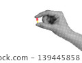 Hand holding a medical pill isolated on transparent background with vintage newspaper print texture. Concept of healthcare, medicine, treatment and pharmaceutical industry 139445858