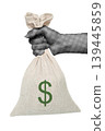 Hand holding a money bag with dollar sign isolated on transparent background with vintage newspaper print texture. Concept of finance, wealth, profit and business economy 139445859
