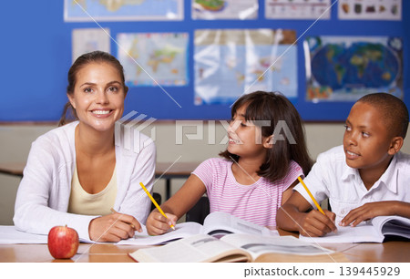 Teacher, portrait and school kids in classroom, books and learning together for development, studying or writing notes. Woman, children and notebook with support, teaching and education with smile Teacher, portrait and school kids in classroom, books and learning together for development, studying or writing notes. Woman, children and notebook with support, teaching and education with smile 139445929